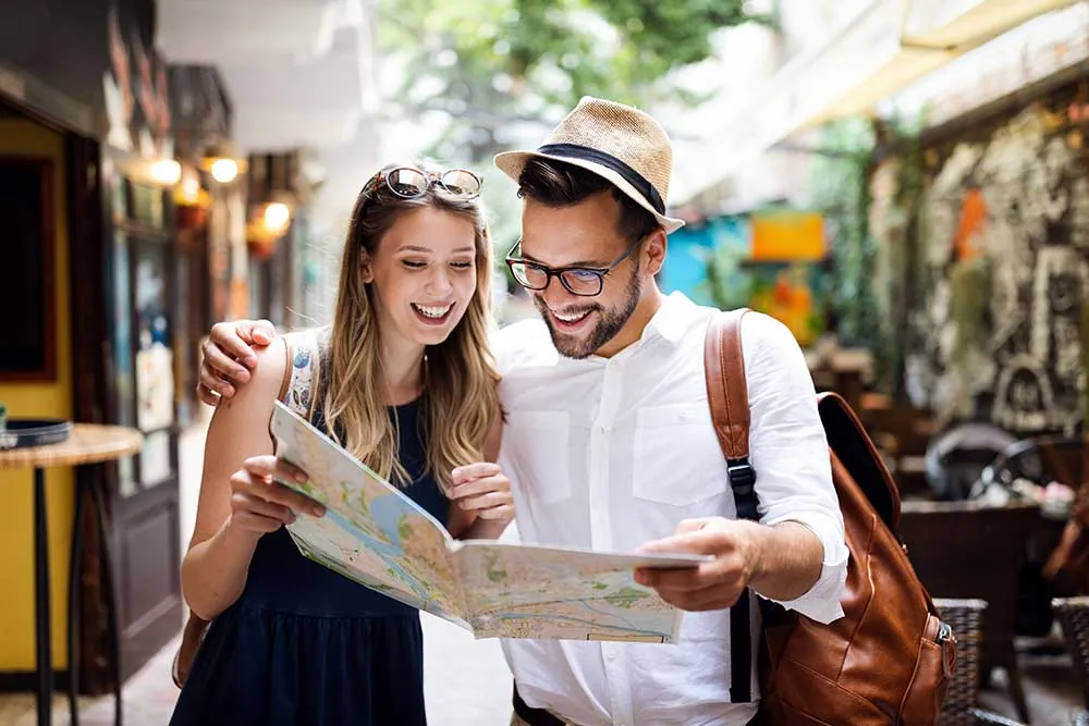 Two travellers planning their route with a map